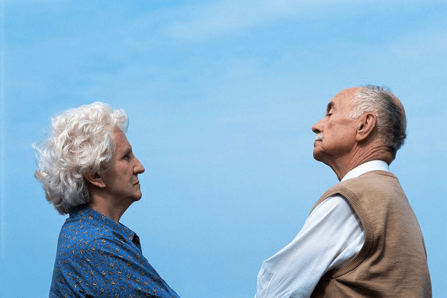Elderly couple in a tense but respectful standoff