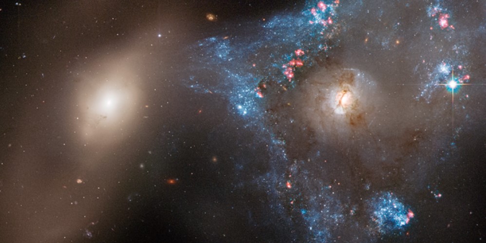 Hubble Telescope Captures Stunning Cosmic Triangle in Star-Forming Galaxy Collision