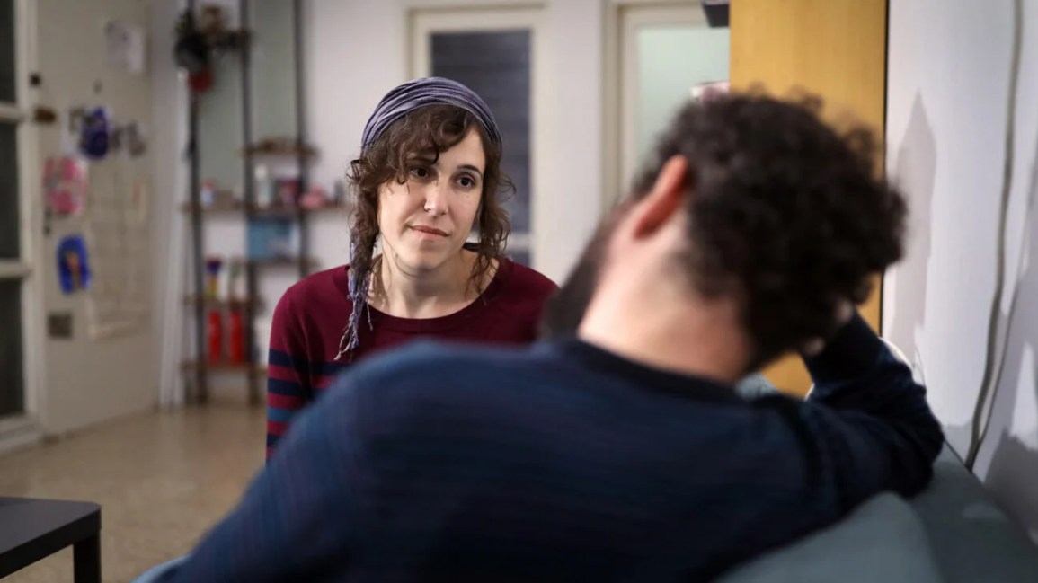 Man and woman having serious conversation on couch