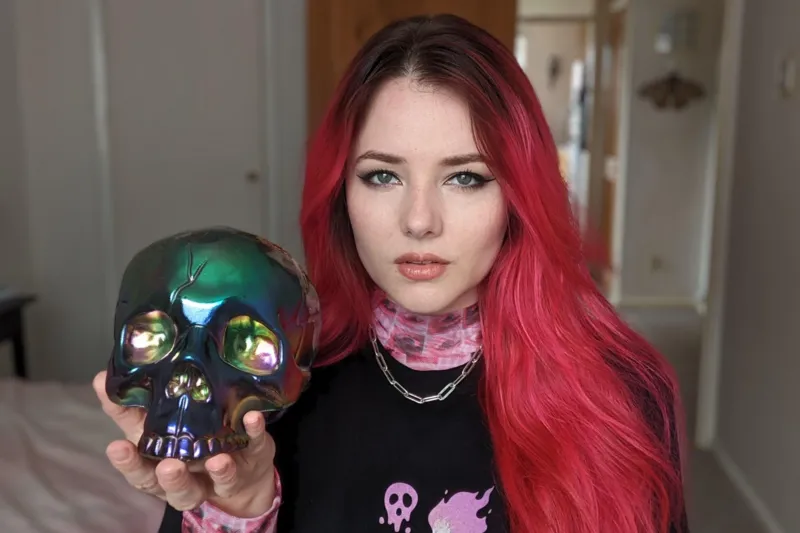 Ash Millman holds an iridescent skull model.
