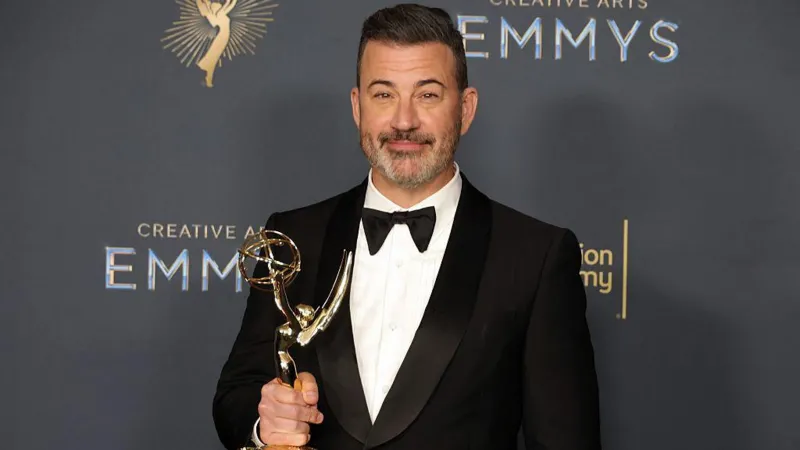 Getty Images Jimmy Kimmel in a tuxedo holding an Emmy award.