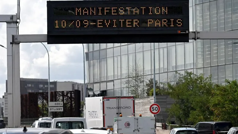 BERTRAND GUAY/AFP A Paris billboard shows in orange - "demonstration 10/09 - avoid Paris"