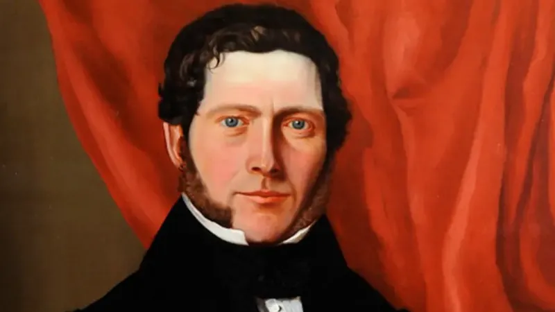 Guernsey Museums & Galleries A painting of William Le Lacheur, he is smiling with his mouth closed and there is a red curtain behind him. He has long brown mutton chops and dark hair