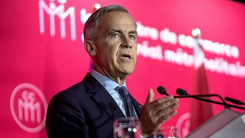Getty Images Canadian Prime Minister Mark Carney speaks at a conference organized by the Chamber of Commerce of Metropolitan Montreal in Montreal, Quebec, he has grey hair and is wearing a navy suit with a blue shirt. There is a pink background behind him.