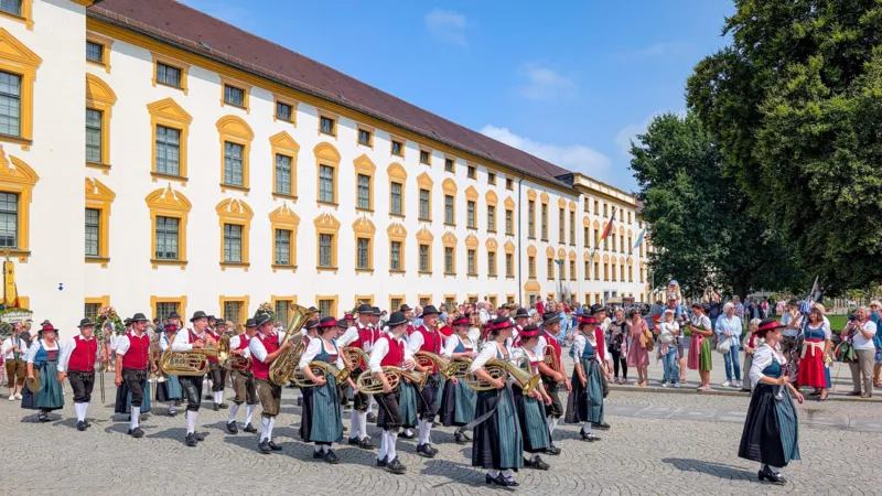 NurPhoto via Getty Images People in traditional Bavarian dress take part in a parade carrying brass instruments