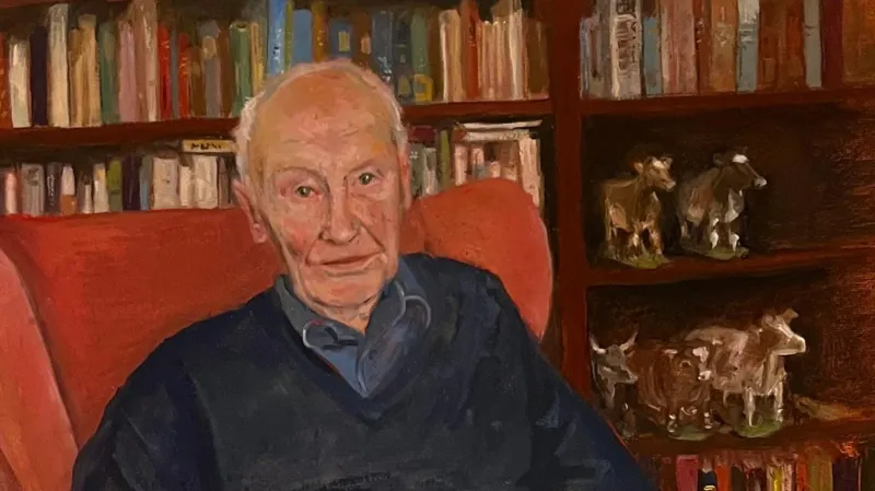 Ella McGee A painting featuring an older man with receding white hair. He is sitting on an orange high-backed chair in front of a large bookcase filled with books and a few ornaments of cows. The man is wearing a navy v-neck jumper and a slightly lighter blue shirt. He is looking directly at the artist.