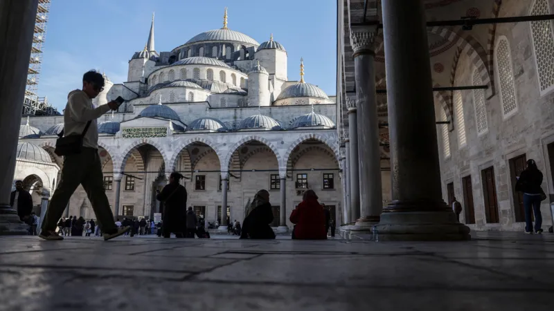 EPA People rest in the shade in front of Istanbul's Blue Mosque.
