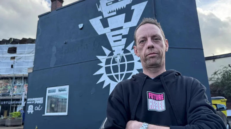 Cal is wearing a black sweatshirt with the words 