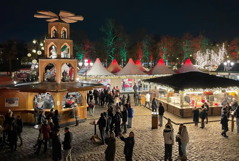 Berlin Christmas market seen from above with wooden stalls and festive lights