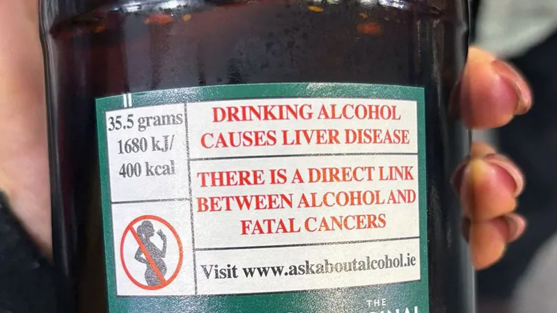 Alcohol causes liver disease and cancers warning label on the back of a bottle of cider