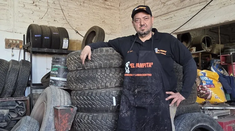 Matedas Zibell Garceda Mechanic Fabio Javier Jime9nez leaning on tyres at his garage