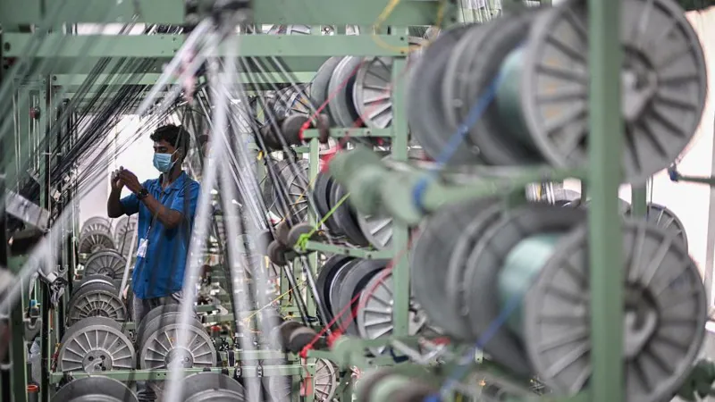 AFP via Getty Images An employee works at a garment factory in Tiruppur, in India's southern state of Tamil Nadu.