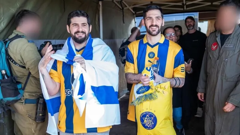 Gali and Ziv Berman both have short brown hair and beards and are wearing yellow and blue striped jerseys
