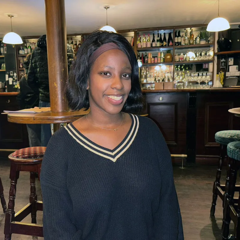 Amanda is standing in a pub