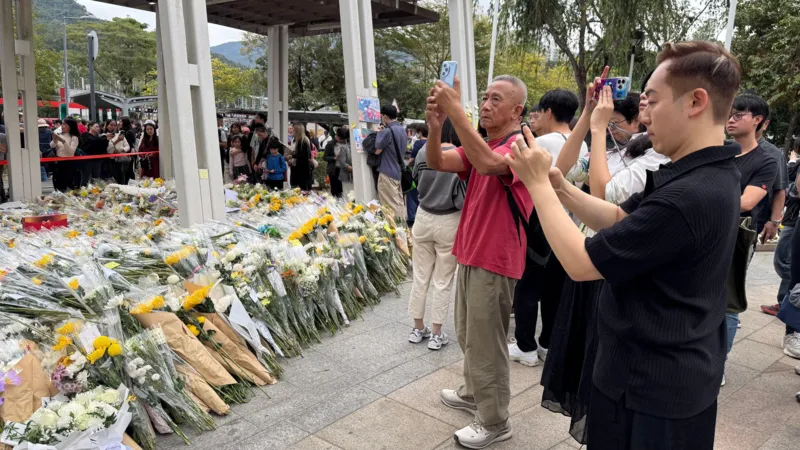 People queuing to pay respects with flowers
