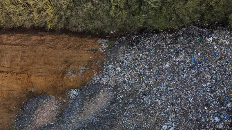 Another view from the air, this time of the edge of the tip and the bare soil of the field beyond.