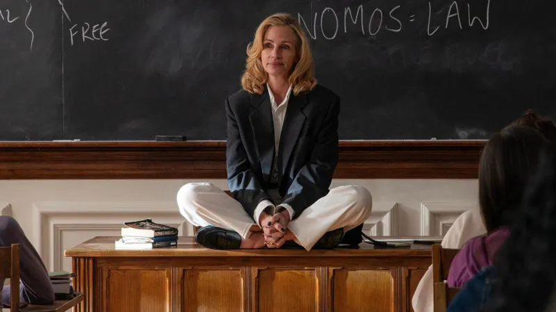 Sony Pictures Classics Julia Robers in After The Hunt, sitting on a desk at the front of a classroom