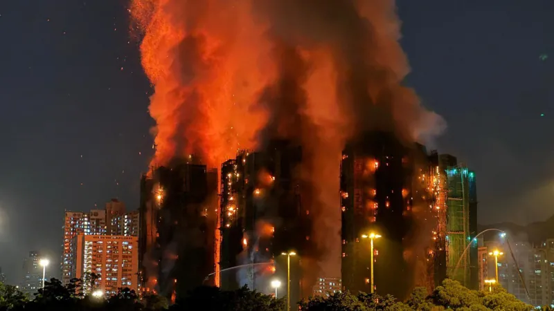 Yan ZHAO / AFP via Getty Images Night shot showing three tower blocks ablaze