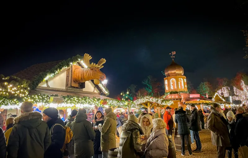 Crowds under red and green lights at a Christmas market in Kingston upon Thames