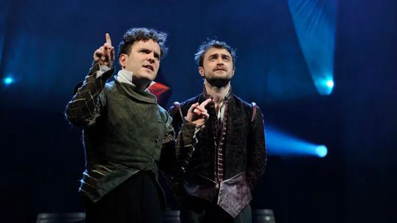 Getty Images Two men in Elizabethan costume stand on stage.