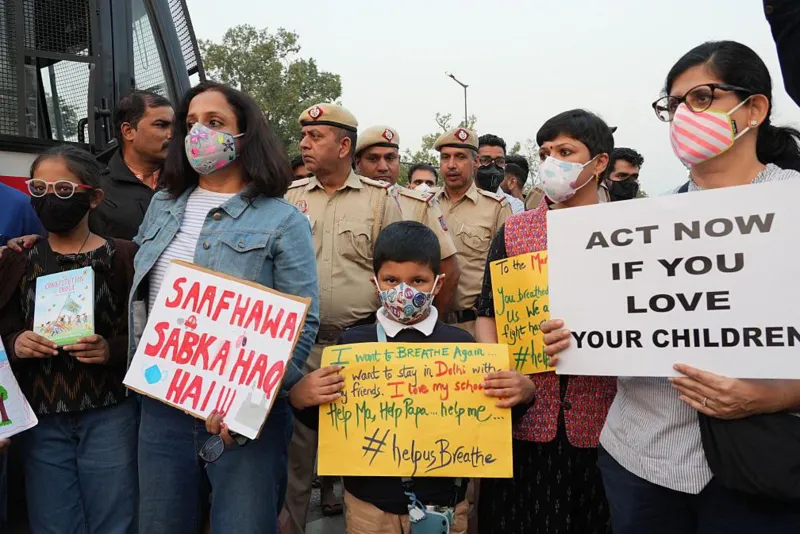 NurPhoto via Getty Images Women and children hold placards to protest against the hazardous air pollution situation in New Delhi, India, on November 9, 2025. (Photo by Bilal Kuchay/NurPhoto via Getty Images)
