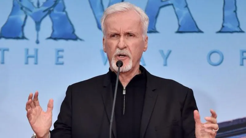 Getty Images James Cameron speaking at an Avatar premiere dressed in black. He is gesticulating with his hands, which are outstretched at shoulder-width.