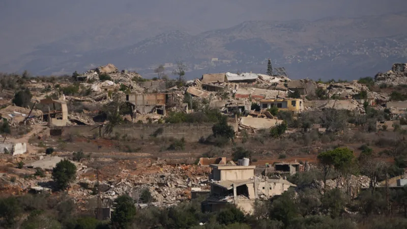 Neha Sharma/INLIBER Destroyed buildings and piles of rubble are seen on a hillside in southern Lebanon.