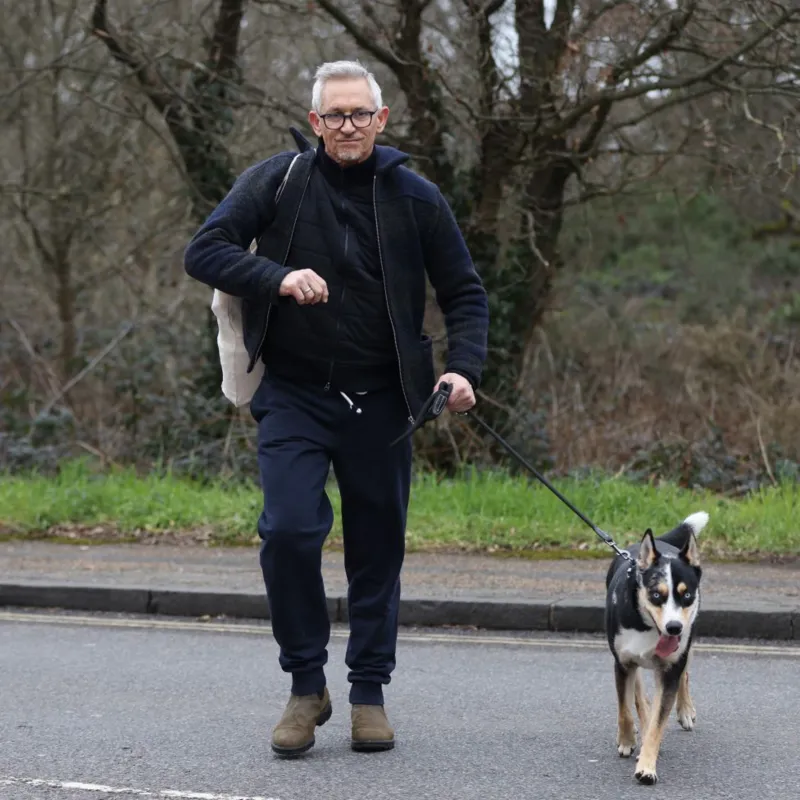 Lineker walking a dog outdoors