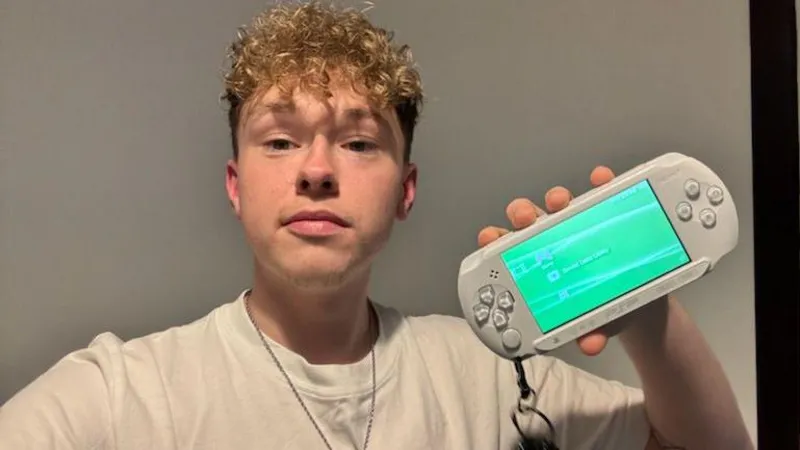 Kyle with a PlayStation Portable handheld console.