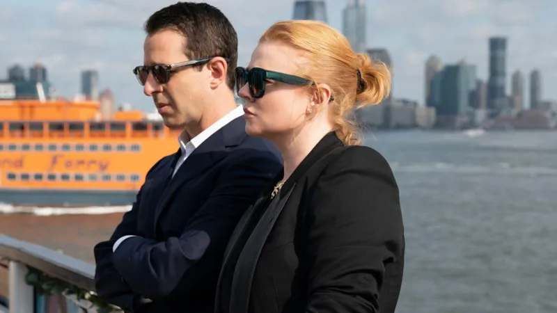Warner Brothers Discovery's Succession stars Jeremy Strong and Sarah Snook by the water with NYC skyline in the background