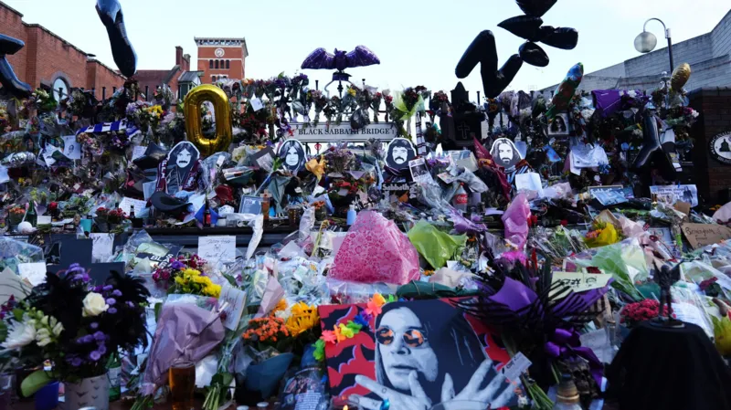 PA Media Floral tributes left at the Black Sabbath Bridge bench on Broad Street in Birmingham in memory of Black Sabbath frontman Ozzy Osbourne
