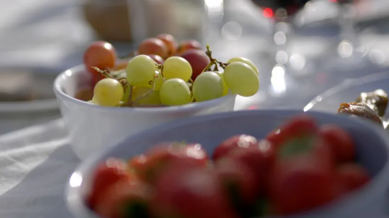 Close-up of grapes and strawberries on a table.