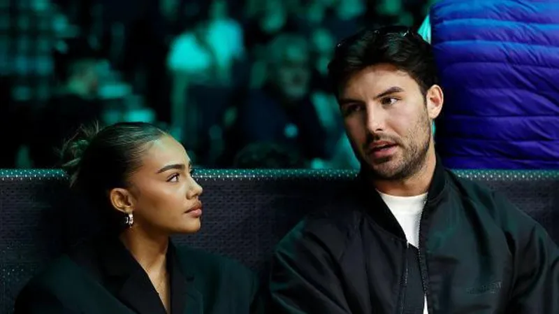 Getty Images Tennessee Thresher (left) pictured sat on a bench with former Love Island star Liam Reardon (right). Liam has brown short hair, a brown beard and brown eyes and is mid sentence. Tennessee has brown hair slicked back into a bun and looks up at Liam. She wears gold hoops and a black blazer jacket.