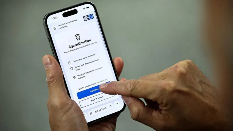Getty Images A man holds a phone showing how to sit an age estimation check from the company Yoti
