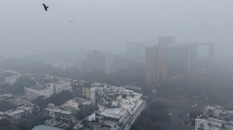 AFP via Getty Images Buildings engulfed in thick haze in Delhi's Connaught Place area on 18 December 2025 